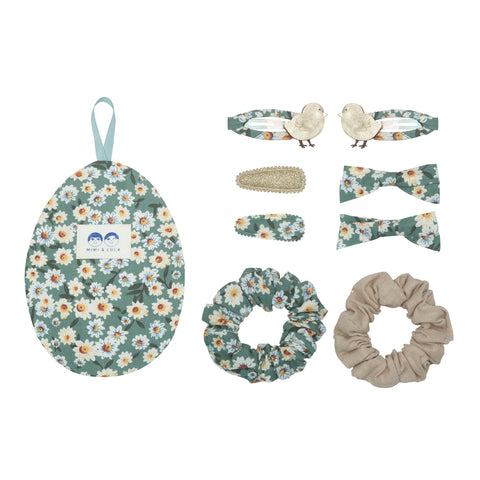Green floral hair accessories in an egg shaped floral bag