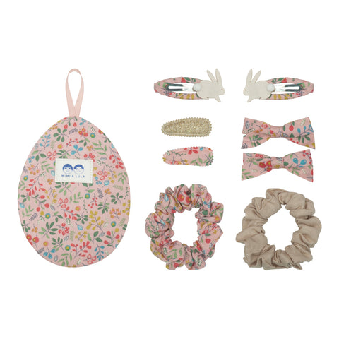 Pink floral hair clips and scrunchies in an egg shaped floral bag