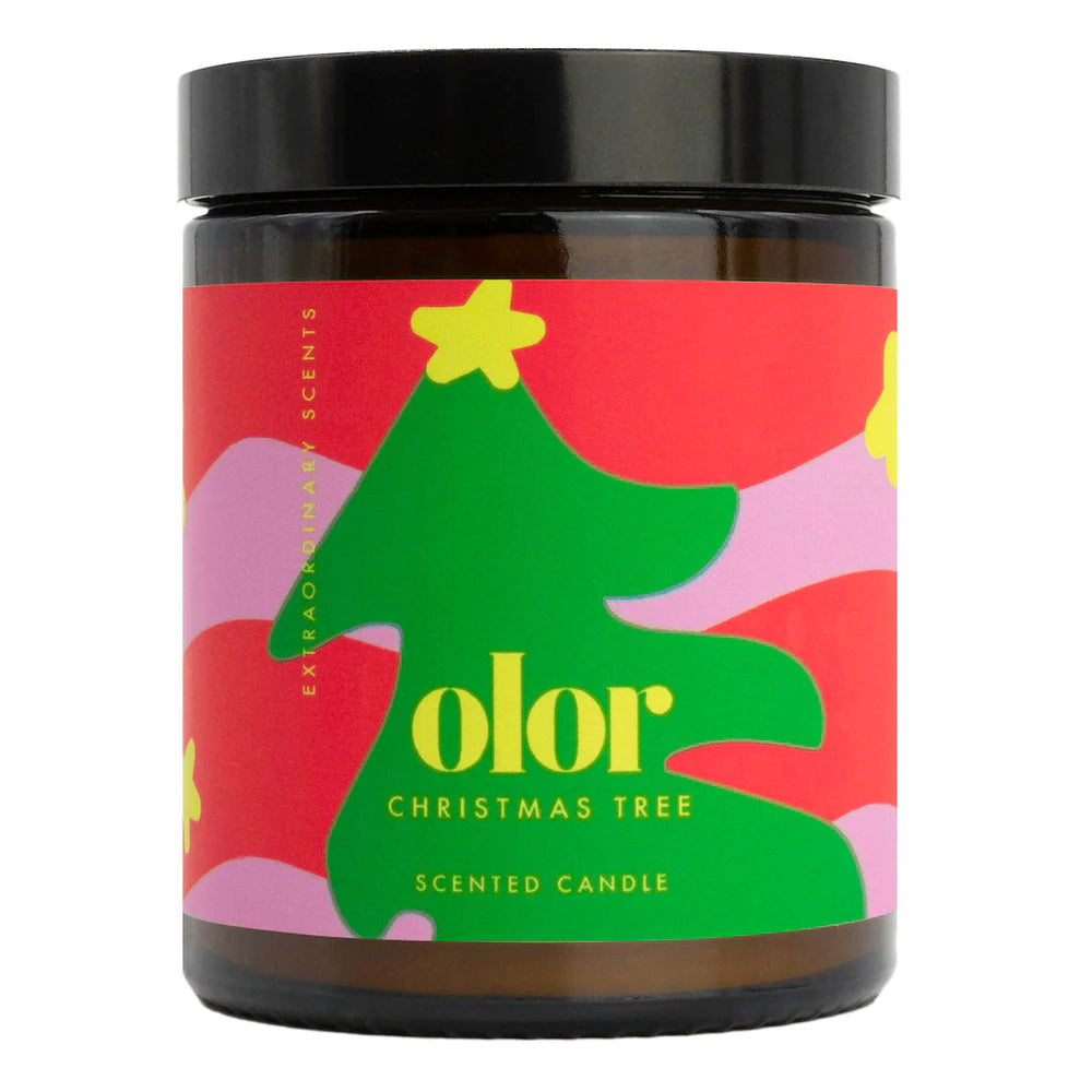 Scented candle in brown jar with colourful christmas tree label