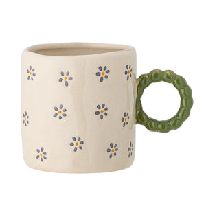 White stoneware mug with green handle and flower prints