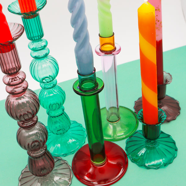 A collection of colourful glass candle holders