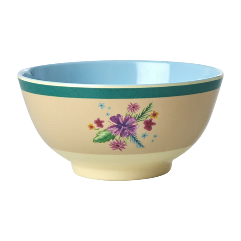 cream melamine bowl with flower print and green edge on outside and light blue inside