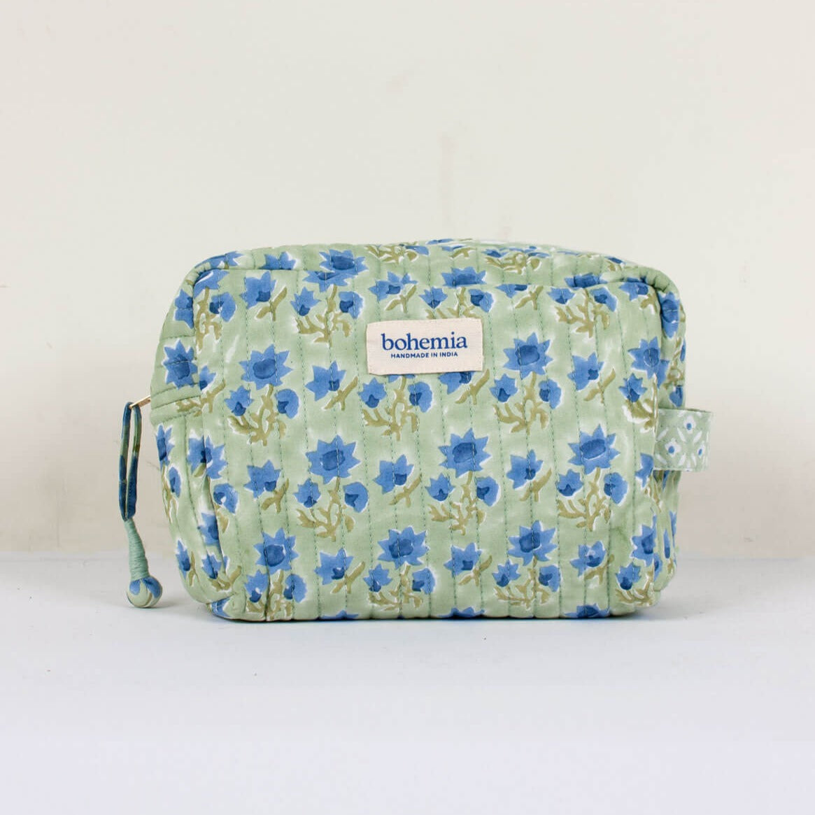 quilted cotton wash bag in sage green with blue flower print
