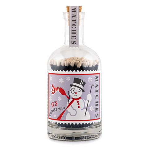 Safety matches in a clear glass bottole with Christmas snowman illustrated stamp label. 