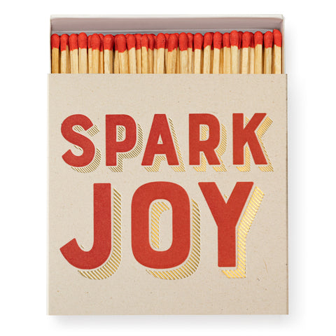 Safety matches in a box with SPARK JOY written in gold and red 