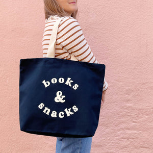 Dark navy cotton canvas tote bag with books & snacks slogan and white handle