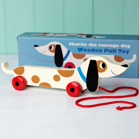 vintage style wooden sausage dog toy in a box