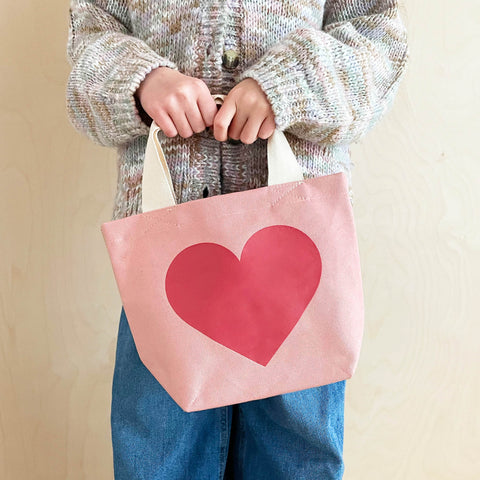 Small pink cotton canvas tote bag with big dark pink love heart print and white handle