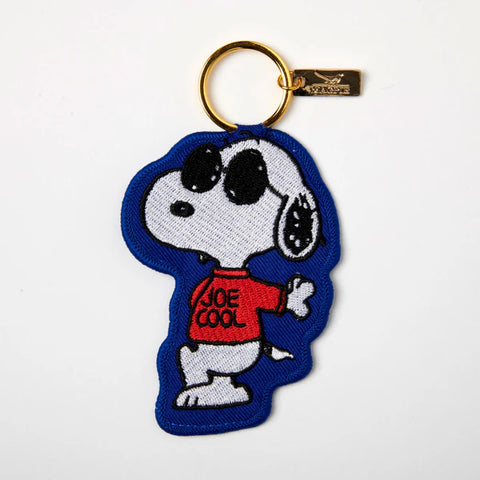 Embroidered applique key charm in blue with Peanuts Snoopy wearing sunglasses and red Joe Cool top