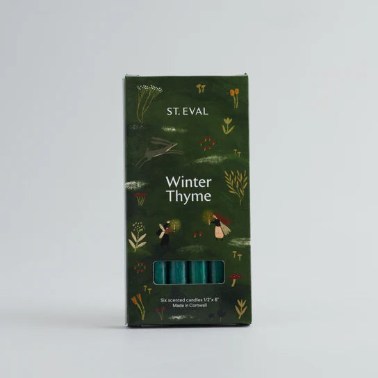 A set of 6 green winter thyme scented candles in a green box with christmas illustration