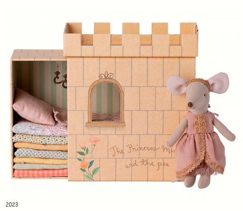 A little mouse doll in a pink and gold dress, with cardboard box castle with colourful mattresses and bedding