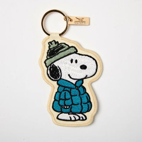 Embroidered applique key charm with Peanuts Snoopy wearing blue puffer jacket and green winter hat