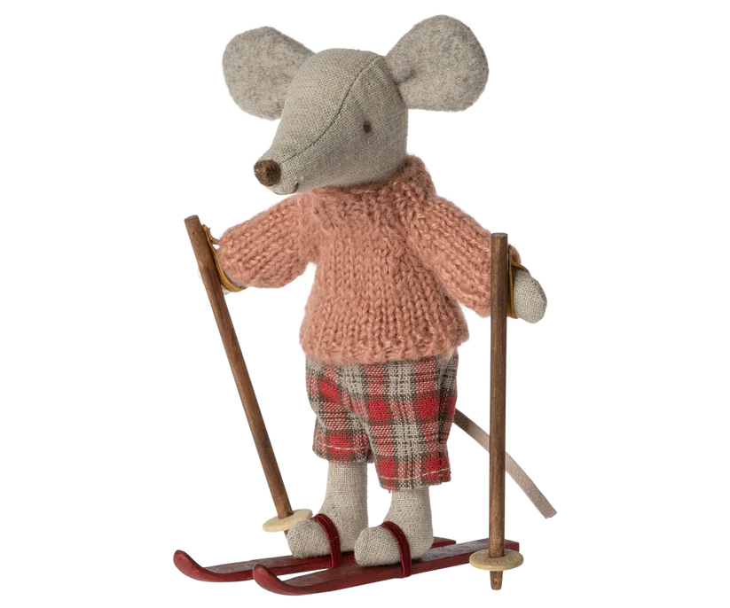 Little stuffed mouse doll wearing pink jumper and red tartan trousers, and red ski 