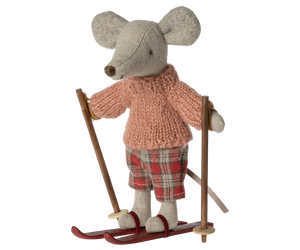 Little stuffed mouse doll wearing pink jumper and red tartan trousers, and red ski 