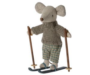 Little stuffed mouse doll wearing grey jumper and green gingham trousers, and ski 