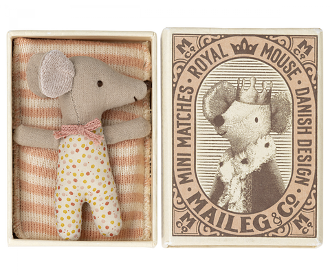 a little baby mouse doll in spotty babygrow, with pink and white stripe bedding, comes in a mini match box 