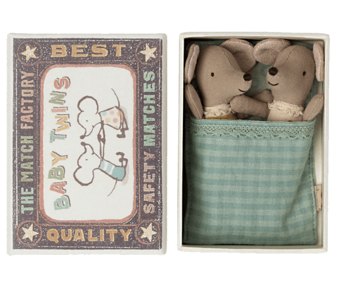 little baby twin mice dolls with green bedding in an illustrated matchbox 